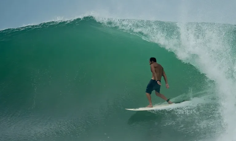 Surfer riding a powerful wave on the coast of Ecuador
