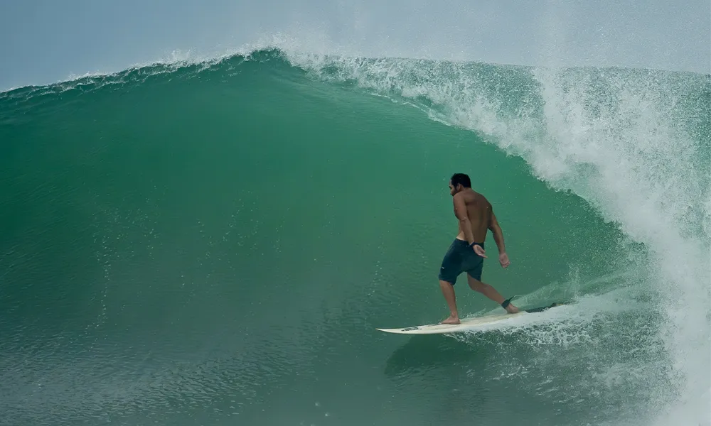 Surfer riding a powerful wave on the coast of Ecuador